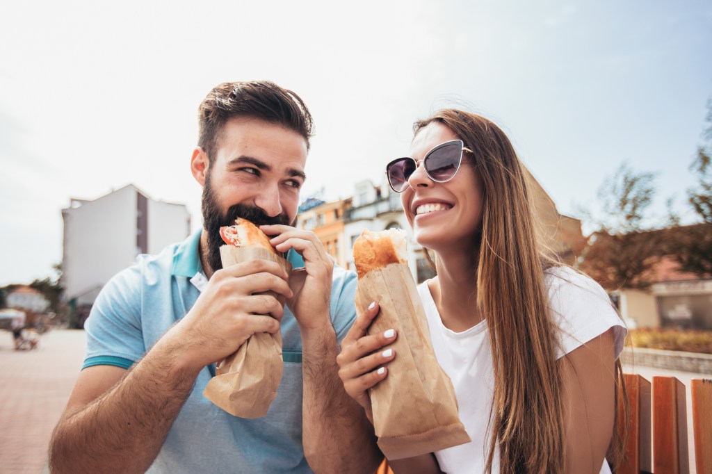 young couple eating sandwiches great 92694781 Ul0pry