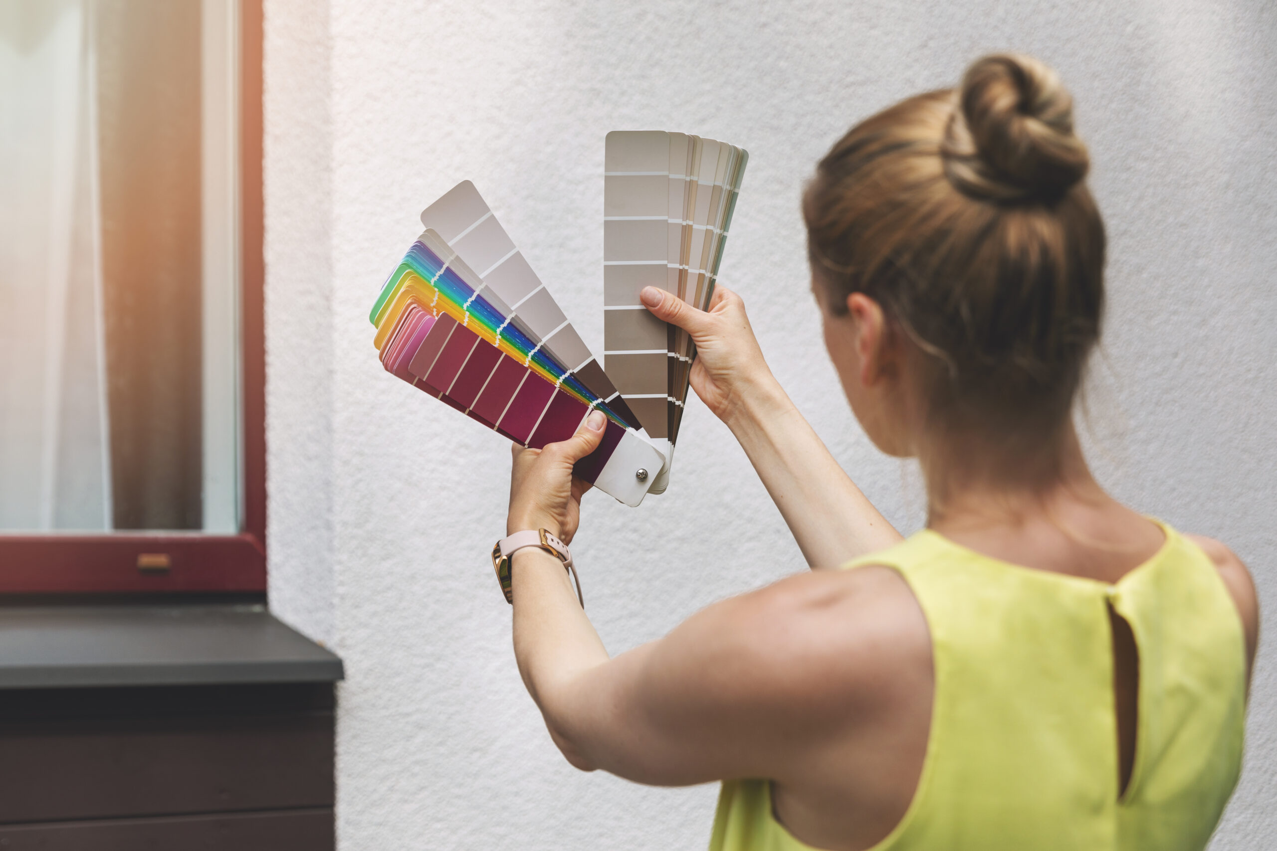 wp content2Fuploads2Fsites2F22F20252F012Fwoman choosing paint color house 93461753 2OSrS1 scaled